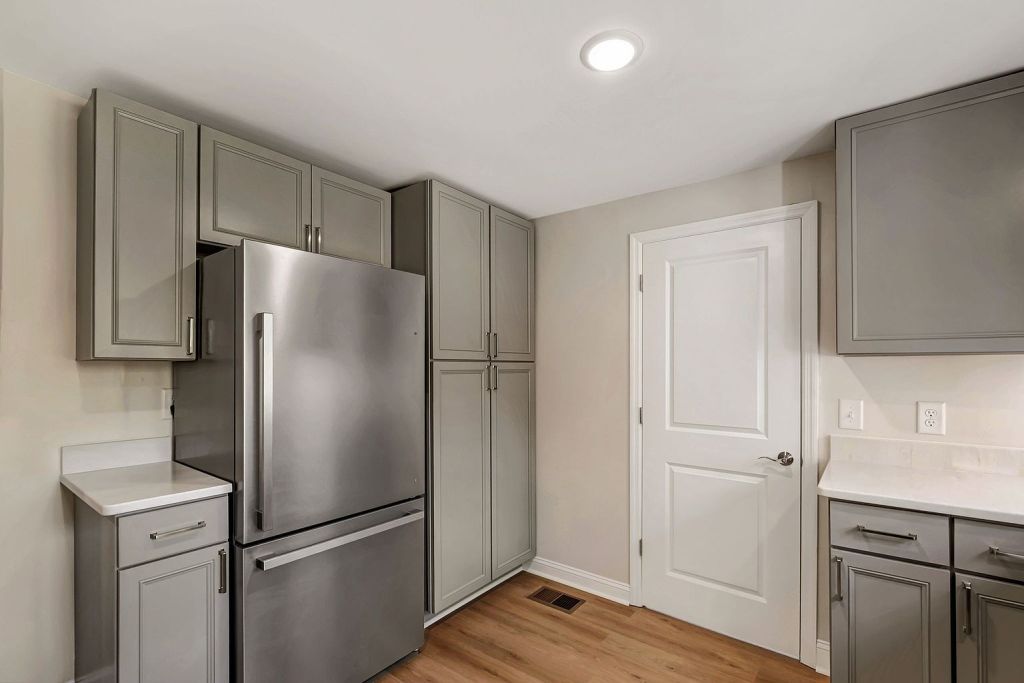 Kitchen remodeling project with charcoal cabinets and new fixtures